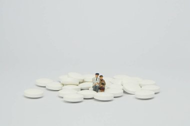 Beyaz hap yığını üzerinde oturan yaşlı çift şekil.