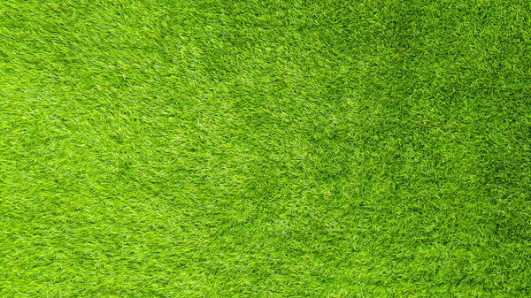 The artificial green grass pattern texture background.