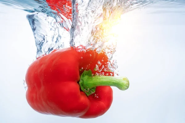 Red bell peppers in ecological clear water, reflected by a solar reflex Copy space.. Close-up. — Stock Photo, Image