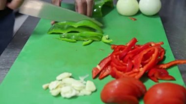 Aşçı tahtada bir bıçakla taze sebzeleri keser. Yatay video.