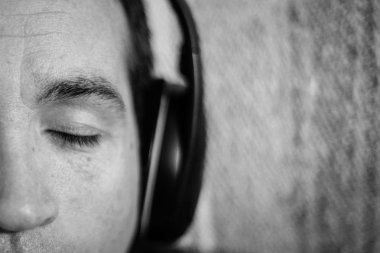 Buenos Aires / Arjantin - 6 Mayıs 2018: A yakın çekim bir adamın yüzü gözleri kapalı. Adam kulaklık aracılığıyla müzik dinlemek.