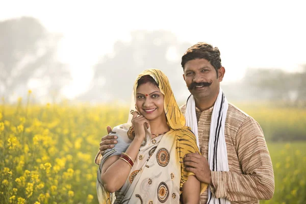 站在油菜籽田的农村夫妇 — 图库照片