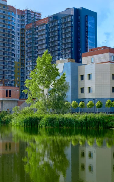 modern building in the park. lake in front of the house. City Park