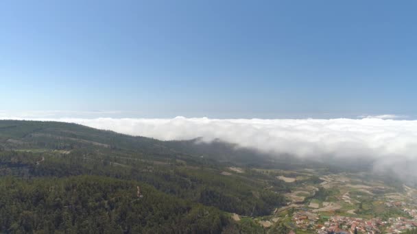 テネリフェ島 晴れた日の雲の上の飛行の小さな町の空撮 スペイン カナリア諸島 で上からショットをドローンします — ストック動画