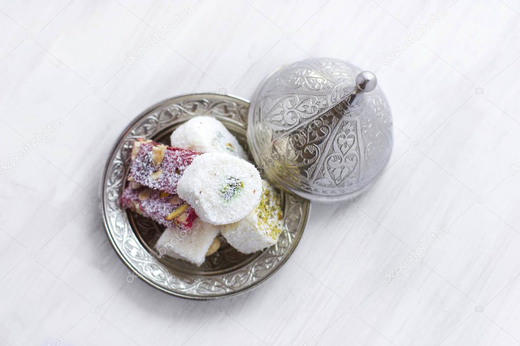 Traditional Turkish sweets lukum on silver saucer with lid