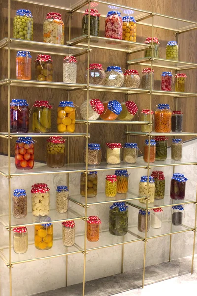 Canned fruits and vegetables, cans with cereals on shelf