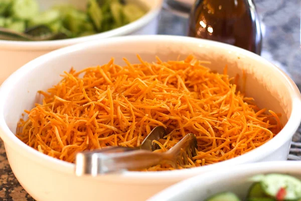 Chopped fresh carrots in the white bowl