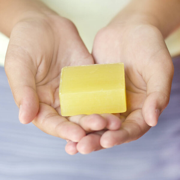 Girl holds handmade soap in the outstretched hands