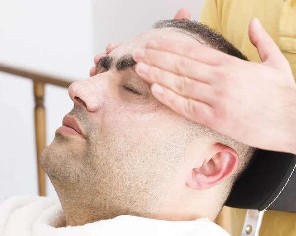 Facial massage for turkish man in barber shop