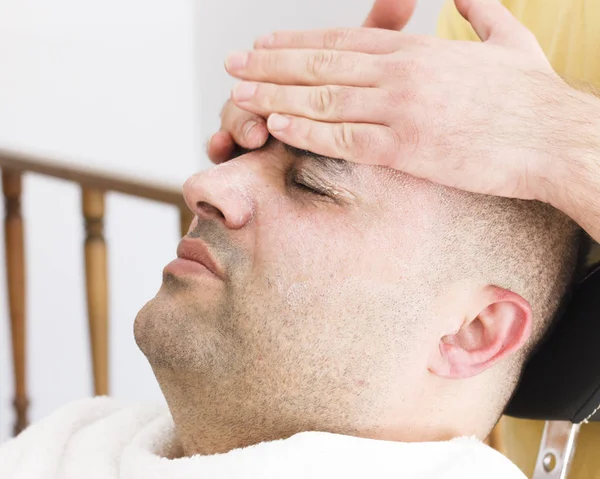 Facial massage for turkish man in barber shop