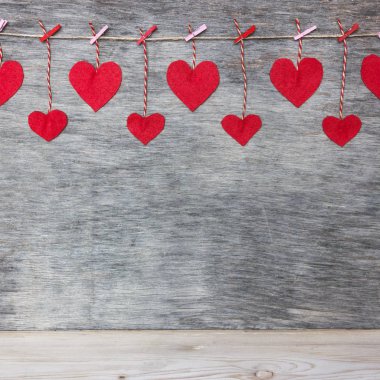 Kırmızı Sevgililer sevgi kalpleri doğal kordon ve pembe pimleri rustik doku arka plan kopya alanı üzerinde asılı