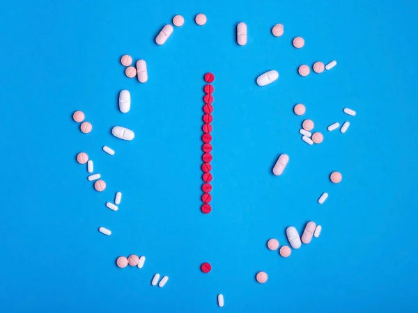 Exclamation mark from red medicine pills on blue background — Stock Photo, Image