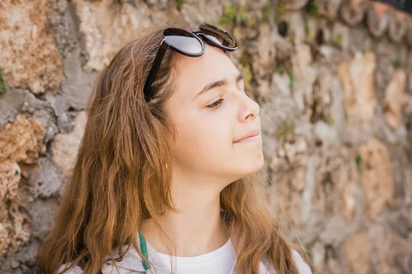 Menina bonita jovem fica perto da antiga parede de pedra da cidade velha de Antalya — Fotografia de Stock
