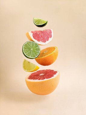 Citrus still life on a light background. Close up view. Healthy food and diet. Orange, lemon, grapefruit, lime. Levitation clipart