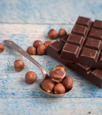 Masada fındık ve fındık olan bir parça çikolata.