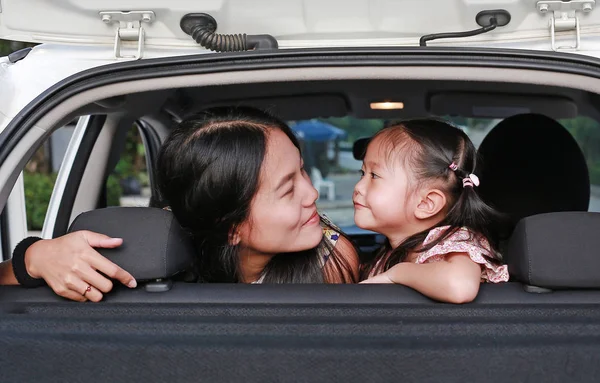快乐的年轻女子和她的小女孩坐在后座 家庭旅行概念 — 图库照片