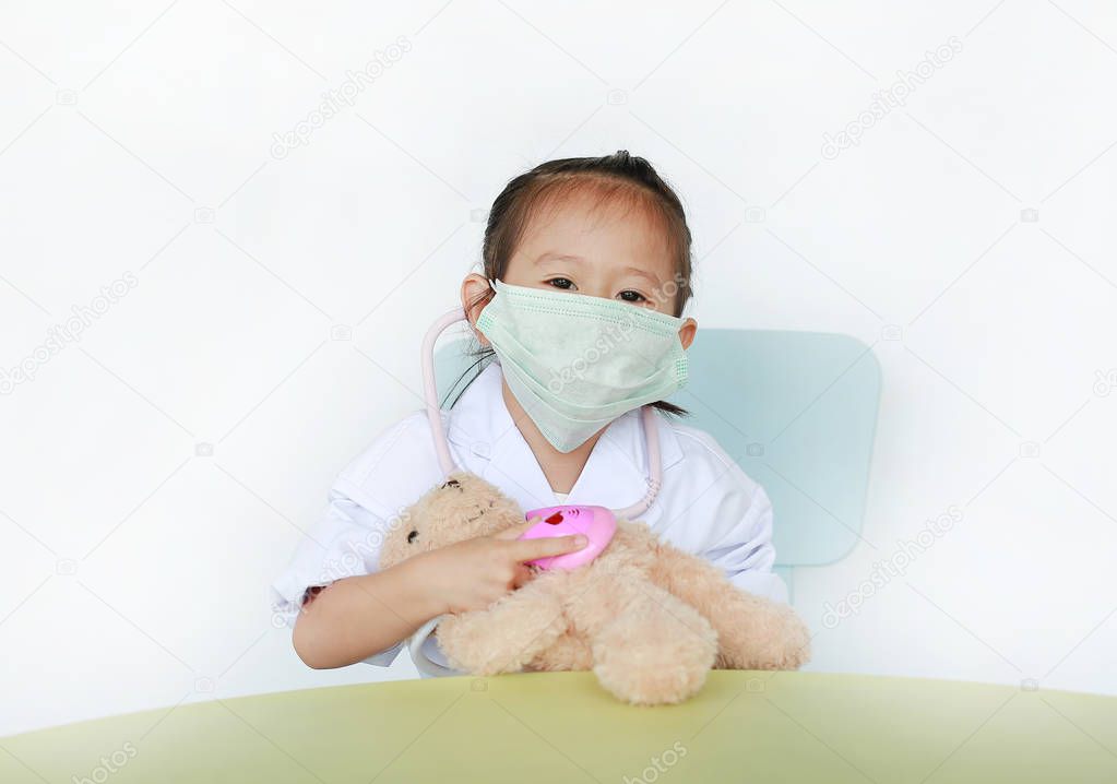 Kid girl plays doctor isolated on white background.
