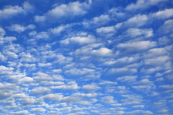 Puffy Clouds on blue sky background.