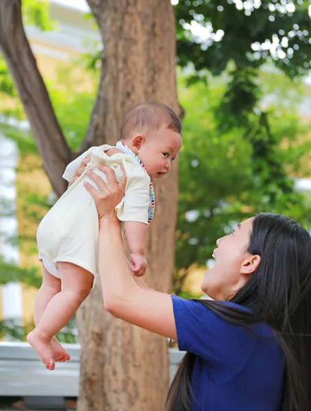 Gelukkig Aziatische Moeder Werpt Haar Baby Armen Tuin — Stockfoto