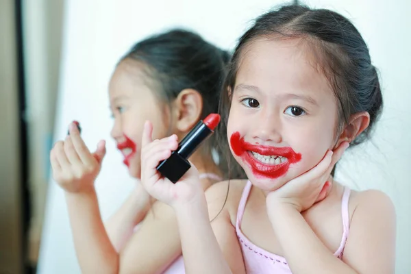 Adorable Niña Divertida Aplicando Lápiz Labial Sobre Cara — Foto de Stock