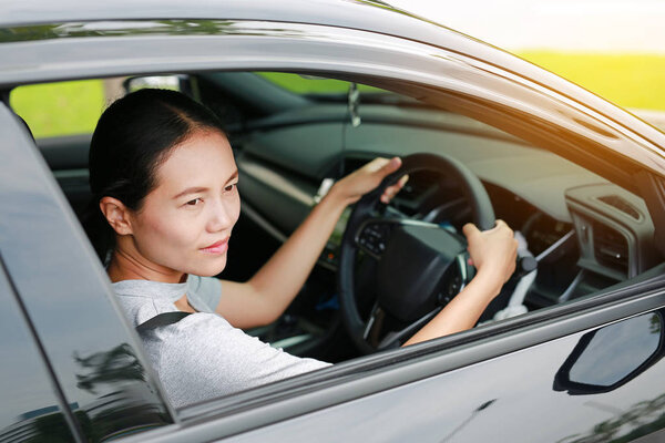 Beautiful young asian woman in a car