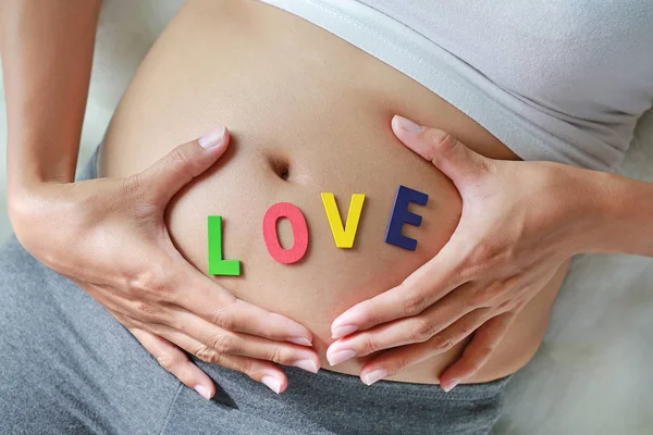 Εσωτερικη Έγκυος Γυναίκα Κάθεται Στο Μαλακό Καναπέ Και Αγγίζουν Την — Φωτογραφία Αρχείου