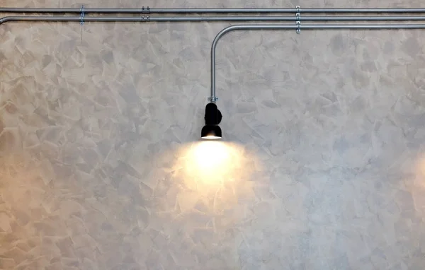 Hanging Lamp decor against gray tile wall background.