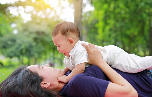 Happy Asian Mom Embrace Her Son Lying Green Garden Funny — Stock Photo, Image