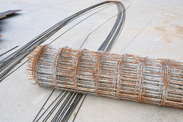 Rolls of wire mesh steel for put a pile on the ground. Steel reinforced rod for concrete construction.
