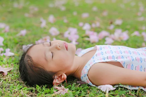 Pretty Little Girl Sleeping Green Grass Fall Pink Flower Garden — Stock Photo, Image