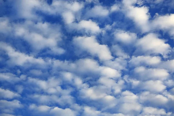 Puffy Clouds on blue sky background.