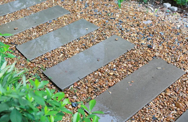 Cement stairs in the garden are wet from the rain. Slip surface.