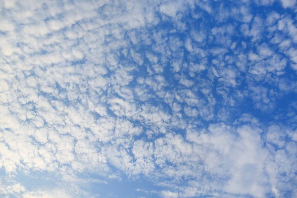 Puffy Clouds on blue sky background.