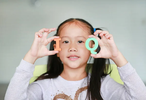 Cute Little Asian Child Girl Holding Alphabet Intelligence Quotient Text — Stock Photo, Image