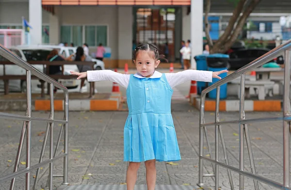 Retrato Pouco Ásia Menina Escola Uniforme Com Estiramento Braços Olhando — Fotografia de Stock