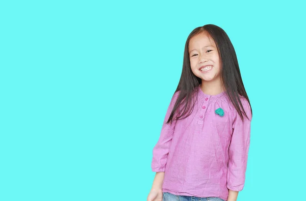 Smiling little Asian child girl isolated on cyan background with — Stock Photo, Image