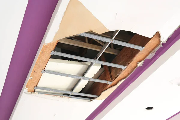 Ceiling panels house damaged from rainwater leakage.