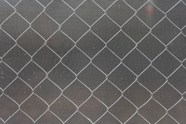 Steel wire mesh fence with mosquito wire screen.