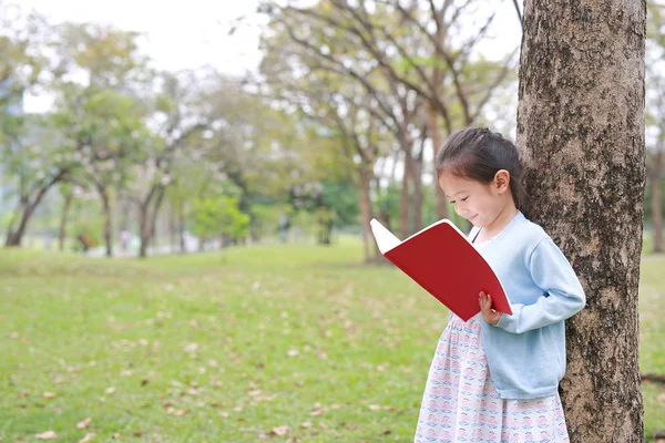 Guapa Niña Leyendo Libro Parque Aire Libre Apoyarse Contra Tronco —  Fotos de Stock