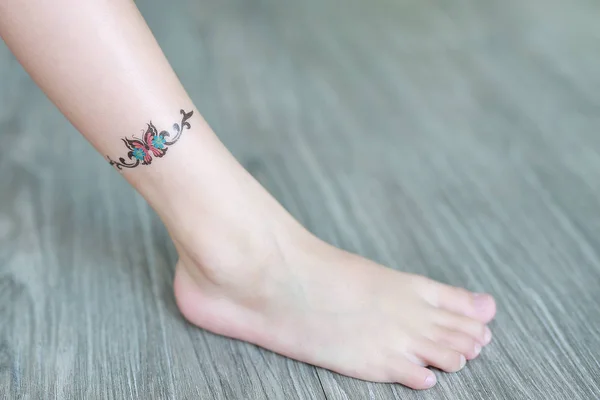 Small flower tattoo sticker on child ankle, Dress up tattoos.