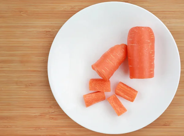 Chopped Carrot White Plate Wooden Board Top View — Stock Photo, Image