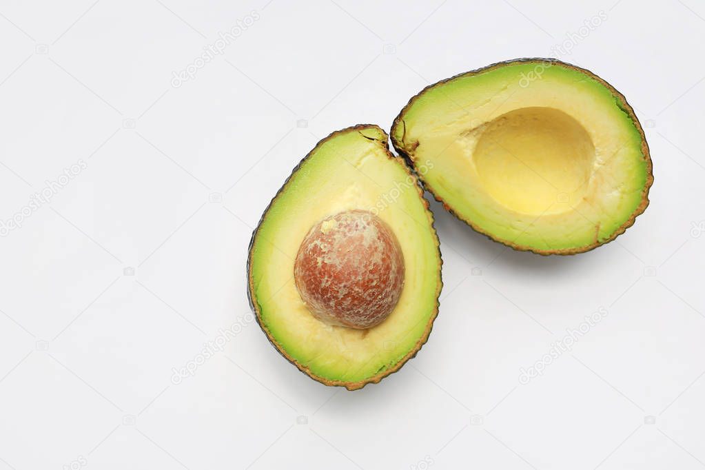 avocado cut in half isolated on white background