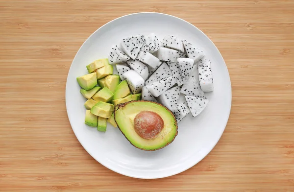Fresh Sliced Fruit Avocado Dragon Fruit White Plate Wooden Board — Stock Photo, Image