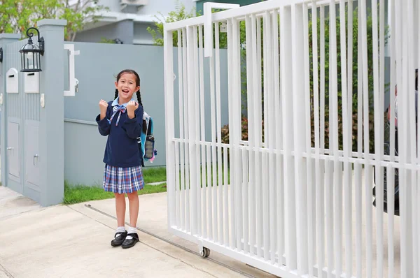 身着幼儿园校服的自信的亚洲小女孩在早上离家去学校之前 举手表决 — 图库照片