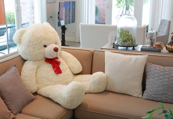 Fabric sofa with big bear doll in living room