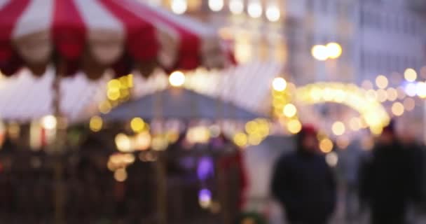 Night City Boke Lights. Festive Illumination, Natural Defocused Blurred Bokeh Background Effect Of Traditional Christmas Trading Houses In Winter Evening Night In Festive Lighting — Stock Video