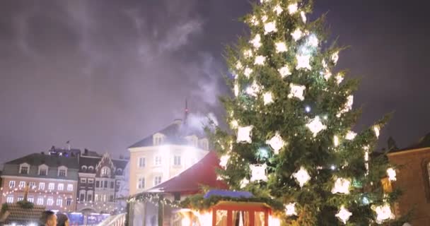 Riga, Letland - 18 december 2017: Mensen wandelen in de traditionele kerstmarkt op het plein van de koepel. Ruilhuizen in de winter 's avonds — Stockvideo