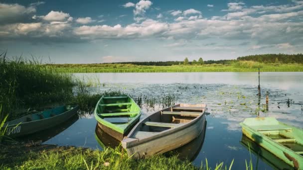 Lago ou rio e velhos barcos de pesca de remo de madeira na bela noite ensolarada de verão — Vídeo de Stock