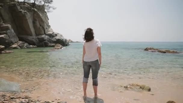 Tossa De Mar, Girona, España. Joven mujer caucásica manos arriba disfrutando de la vida, de pie en la playa del mar de verano. Mar Balear — Vídeo de stock