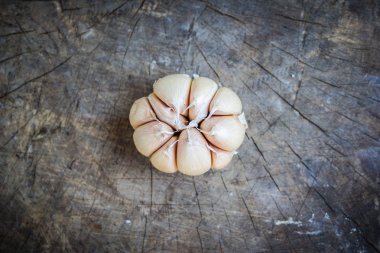 Eski ahşap arka plan üzerinde yemek pişirmek için sarımsak.